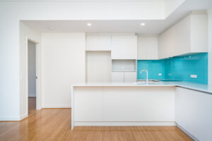 Clean,Interior,Of,Apartment,Kitchen,With,Turquoise,Splashback,And,Light